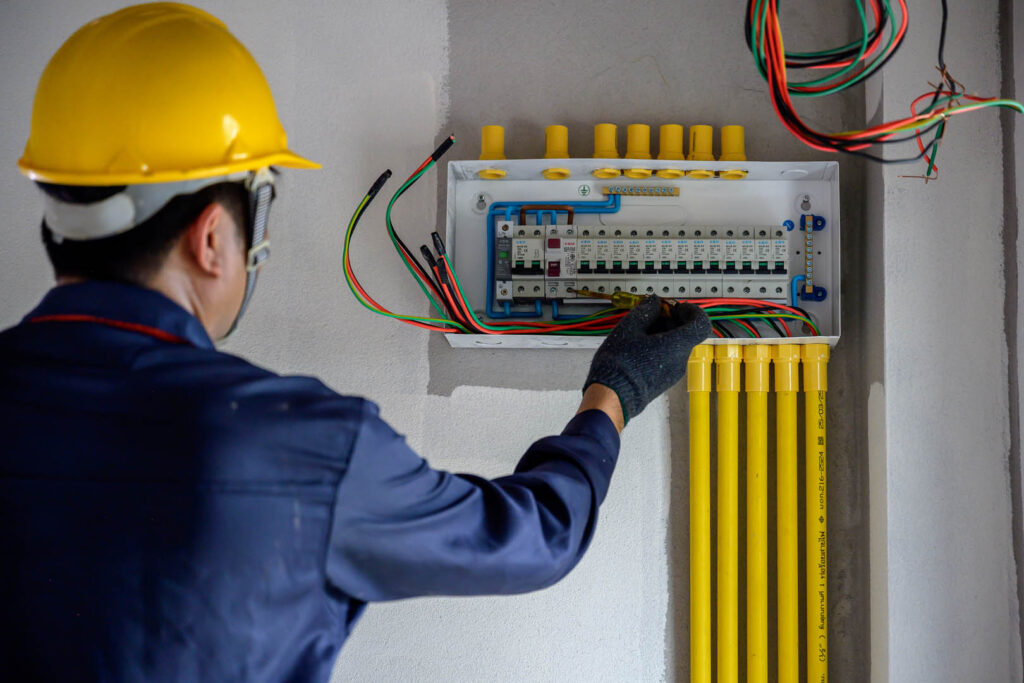 An electrician or an electrical engineer Install and test outlets and switches for electricity in houses and buildings.